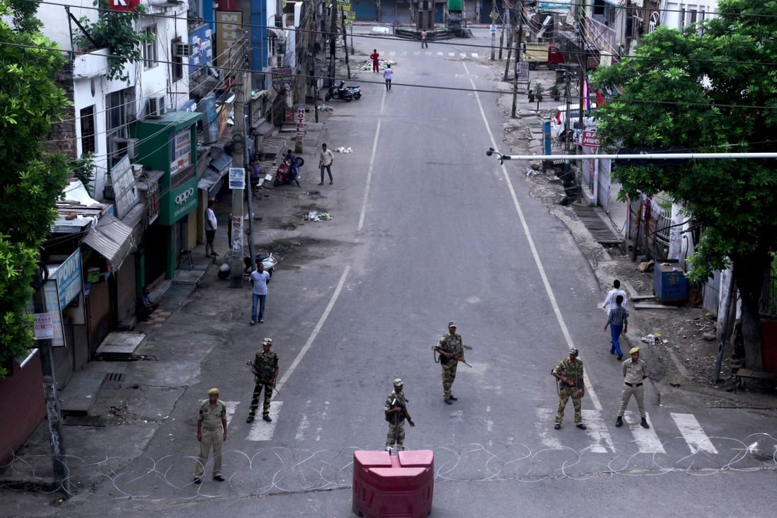 Security personnel stand guard on a deserted street in Jammu on August 6. India has revoked the special status of the Muslim-majority state of Jammu and Kashmir. Photo: AFP