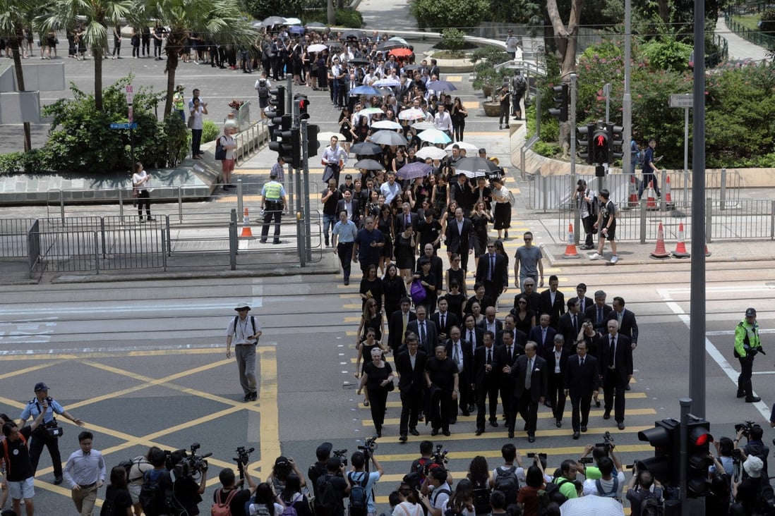 Members of the city’s legal profession march in silence from Chater Garden to the Department of Justice. Photo: Sam Tsang