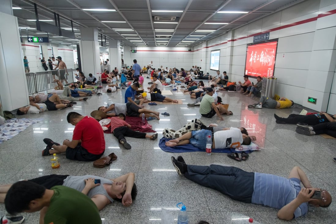Residents of Hangzhou in eastern China try to beat the heat by taking refuge in an air-conditioned subway station. Photo: Imaginechina