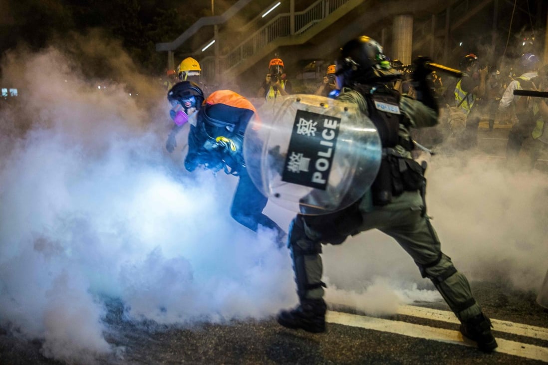 Police fire tear gas during a protest in Hong Kong on August 4. Photo: Isaac Lawrence / AFP