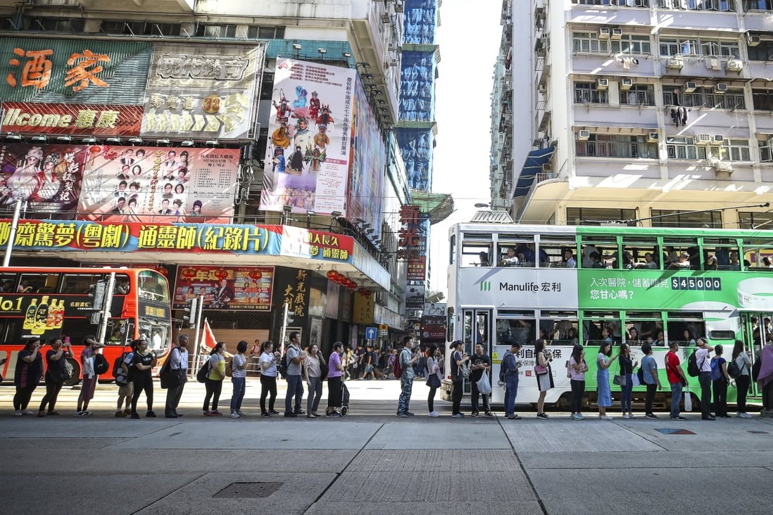 Commuters divert to other transport methods on King's Road as anti-government protesters stopped MTR services from departing during a citywide strike on 5 August 2019. Photo: Winson Wong