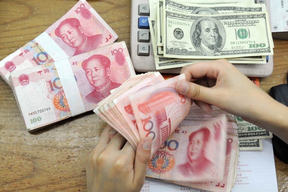 China's central bank set the midpoint exchange rate at 7.0211 on Monday, the third consecutive trading day that Beijing has set a rate weaker than 7 to the US dollar. Photo: AFP