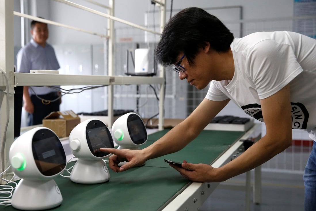 An engineer of Lanchuang Network Technology Corp tests a “Xiaoyi” robot, a Siri-like smart assistant, which links users to the intelligent elderly care system at the company’s headquarters in Weifang, at the eastern coastal province of Shandong, on July 25. Photo: Reuters