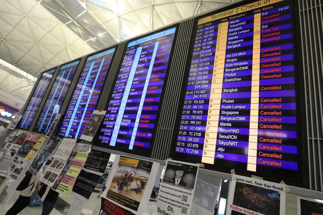 An electronic board shows all departing flights cancelled, as anti-government protesters bring Hong Kong International Airport to a grinding halt. Photo: Felix Wong