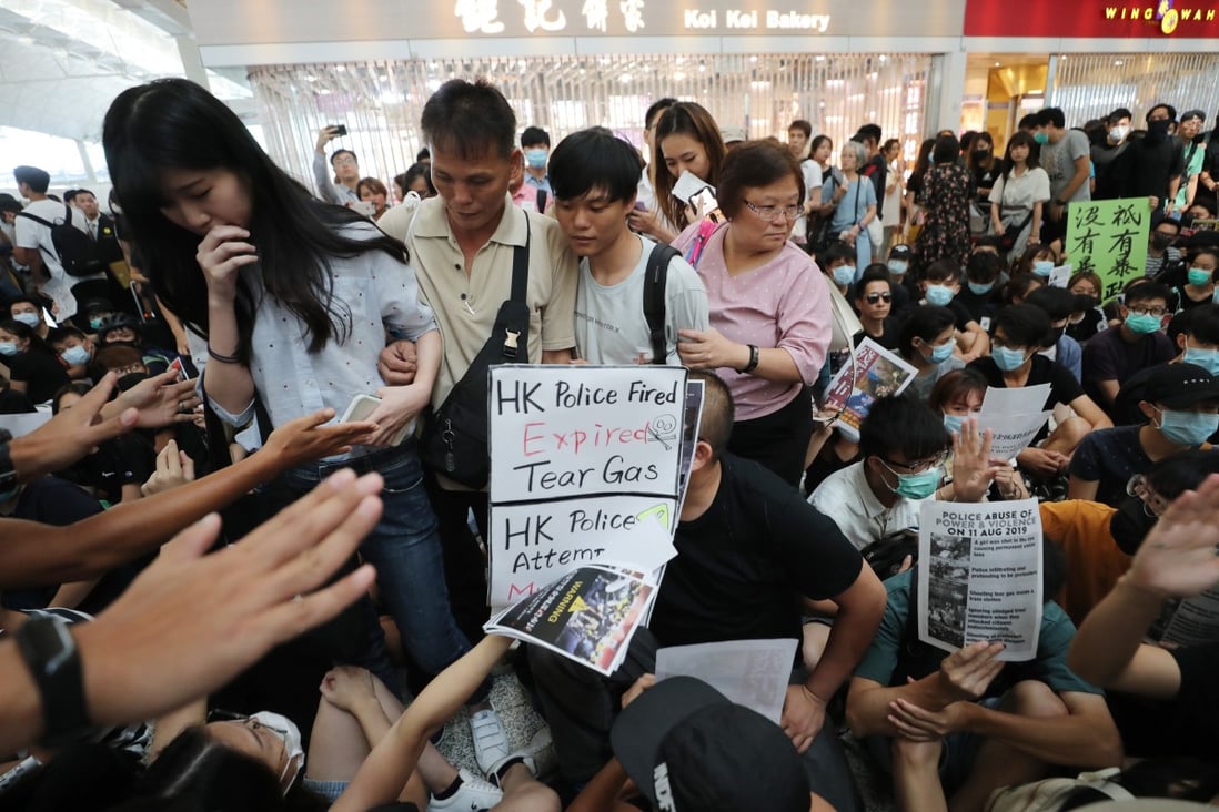Travellers attempting to navigate through the crowd of anti-government protestors at the departure hall of the Hong Kong International Airport, Chek Lap Kok on 13 August 2019. Photo: SCMP / Sam Tsang
