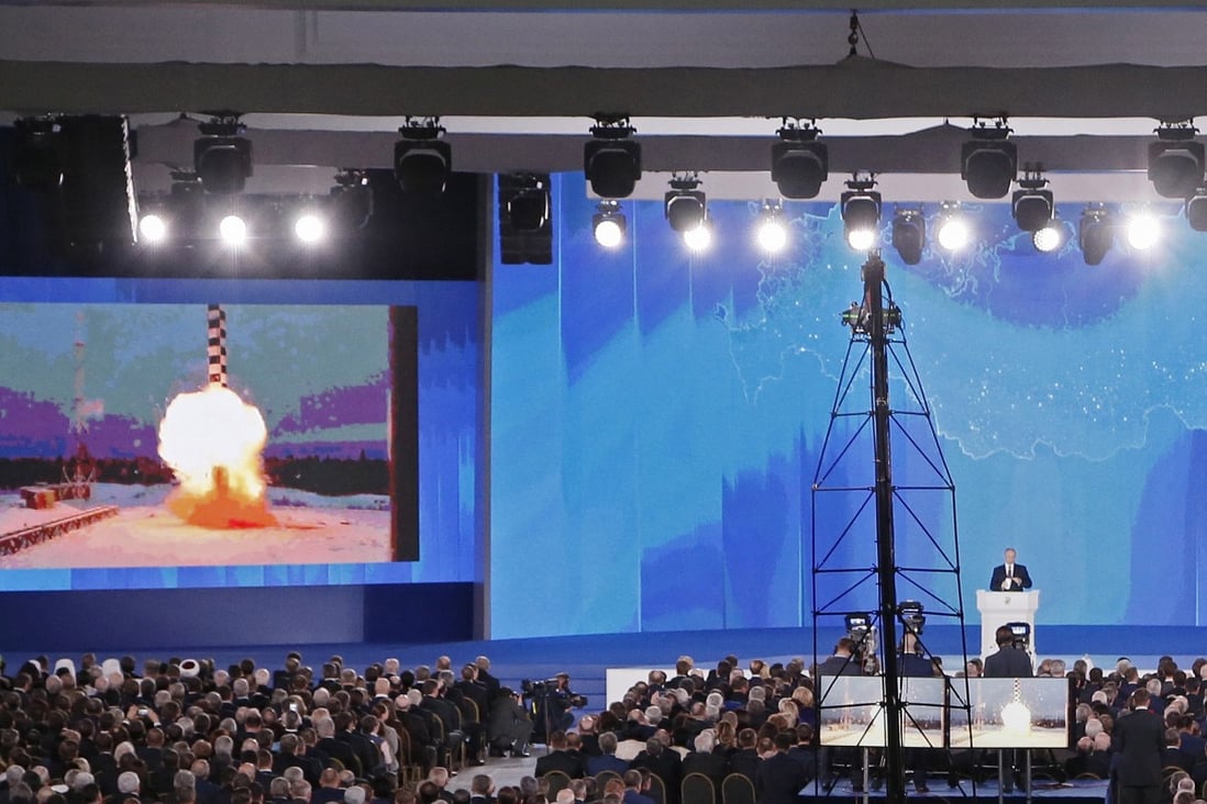 Russian President Vladimir Putin (bottom right) delivers his annual address to the Federal Assembly in Moscow in March 2018 while a screen shows a newly developed cruise missile. Photo: EPA-EFE