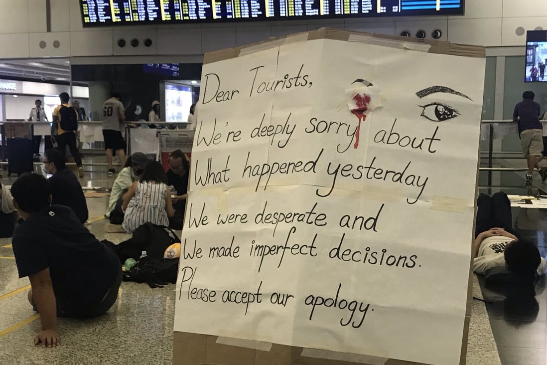 Protesters place a placard in the airport apologising for the trouble on Tuesday. Photo: Kimmy Chung