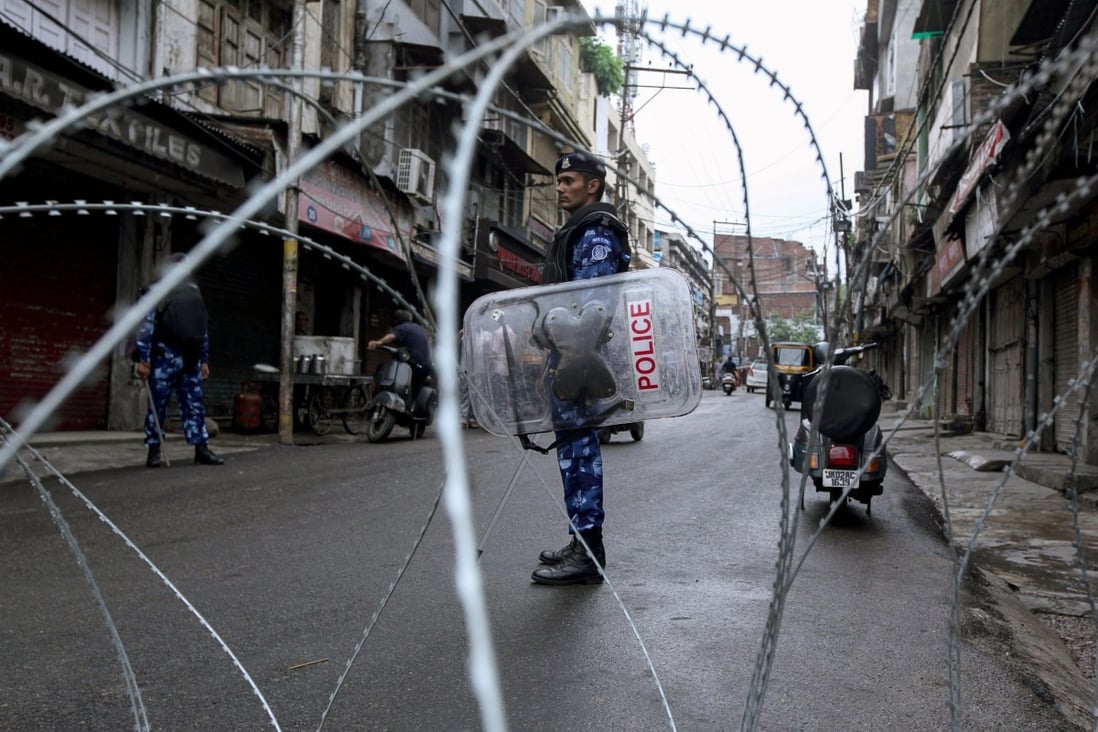 Rapid Action Force personnel stand guard at a roadblock in Jammu city. Photo: AFP