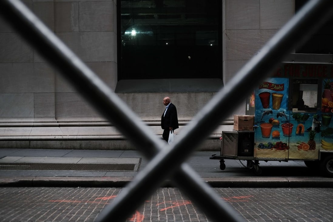 A man walks by the New York Stock Exchange on August 14. Concerns over a recession have sent stocks plummeting. Photo: AFP