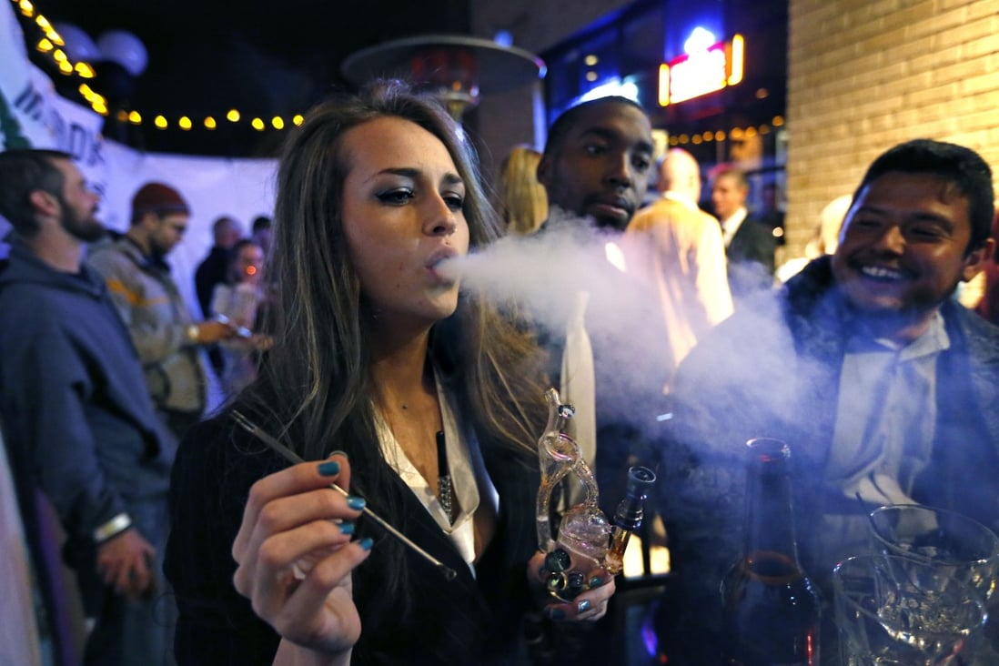 A young woman smokes marijuana at a party in Denver, Colorado. Photo: AP