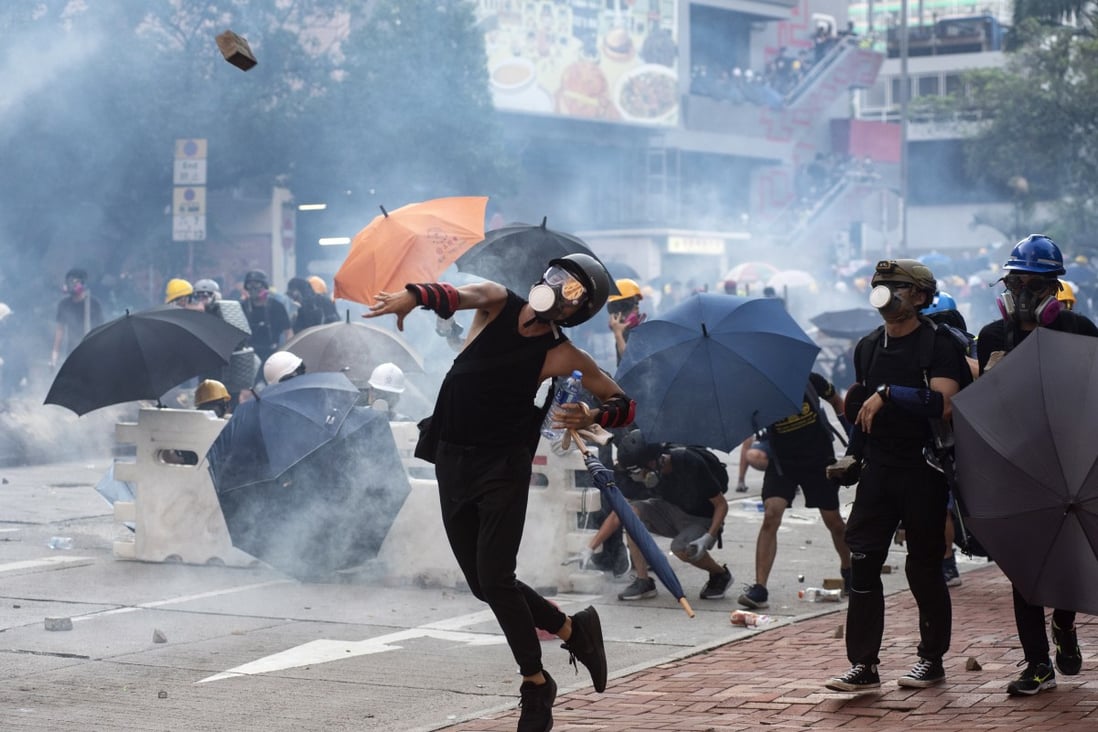 Protesters throw bricks at Hong Kong police, who fired tear gas at them during clashes in Wong Tai Shin area on 5 August 2019. Photo: EPA-EFE