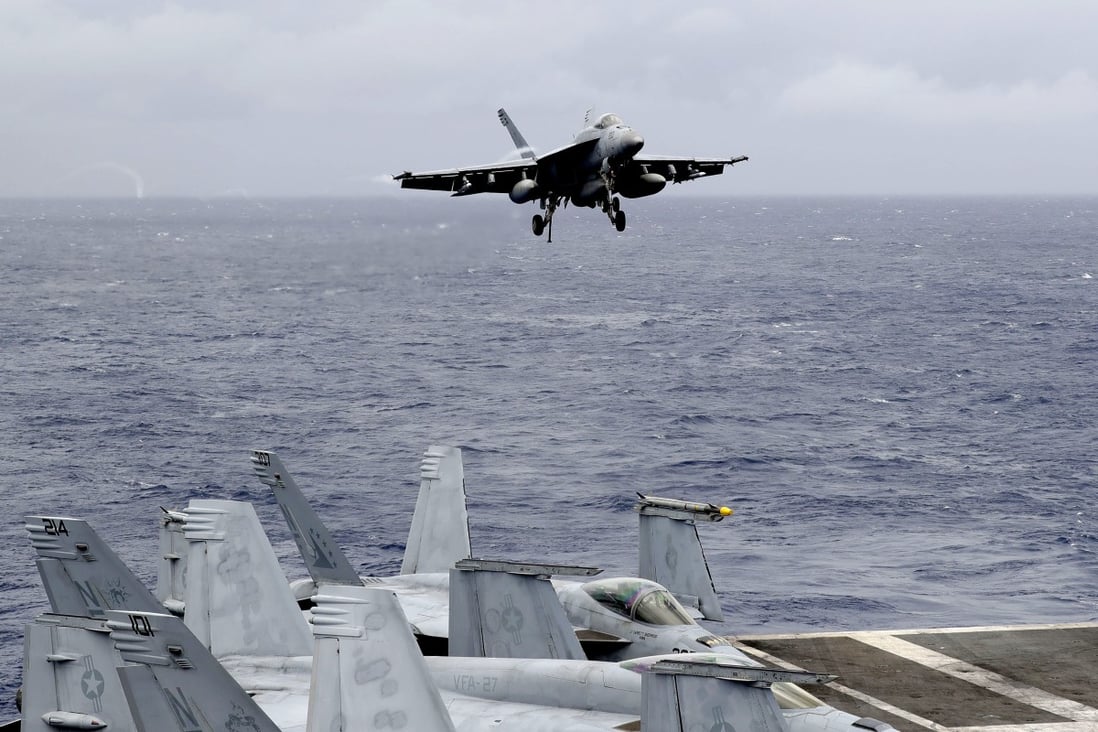 A US fighter jet prepares to land on the aircraft carrier USS Ronald Reagan following a patrol at international waters off the South China Sea. Photo: AP