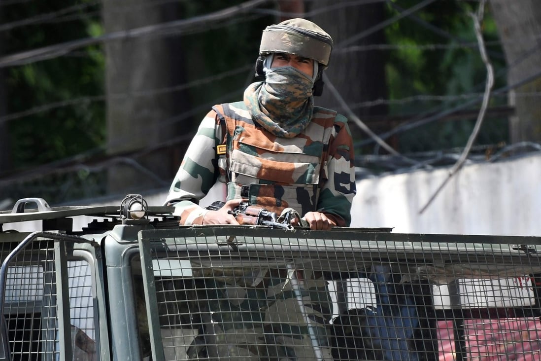 An Indian army soldier stands alert in a truck in Srinagar. Photo: AFP