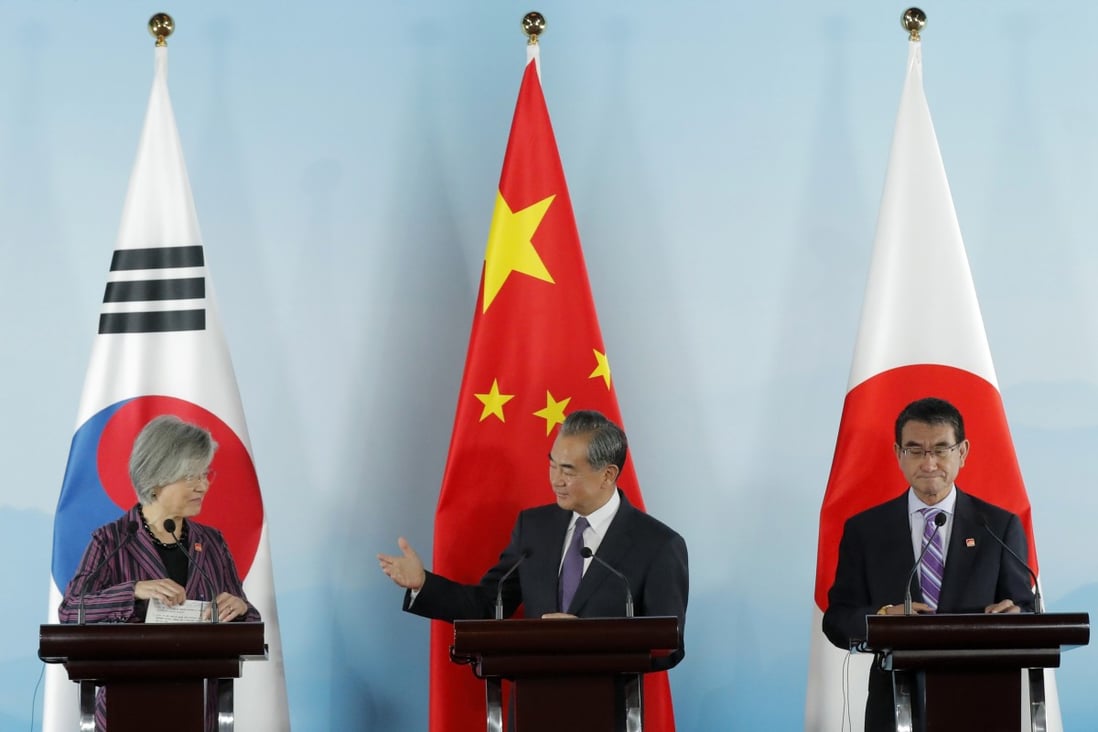 Chinese Foreign Minister Wang Yi gestures to his South Korean counterpart Kang Kyung-wha at a press conference with their Japanese counterpart Taro Kono. Photo: AP