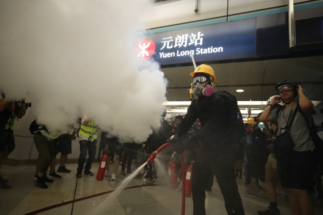 Protesters set off extinguishers and open fire hoses at Yuen Long MTR station. Photo: Winson Wong