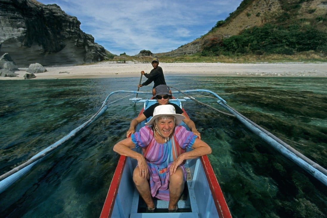A pensioner enjoys a day on an outrigger boat in the Philippines. Low living costs, cheap domestic travel, and lifetime non-immigrant visas are among the attractions of retiring in the country. Photo: Alamy