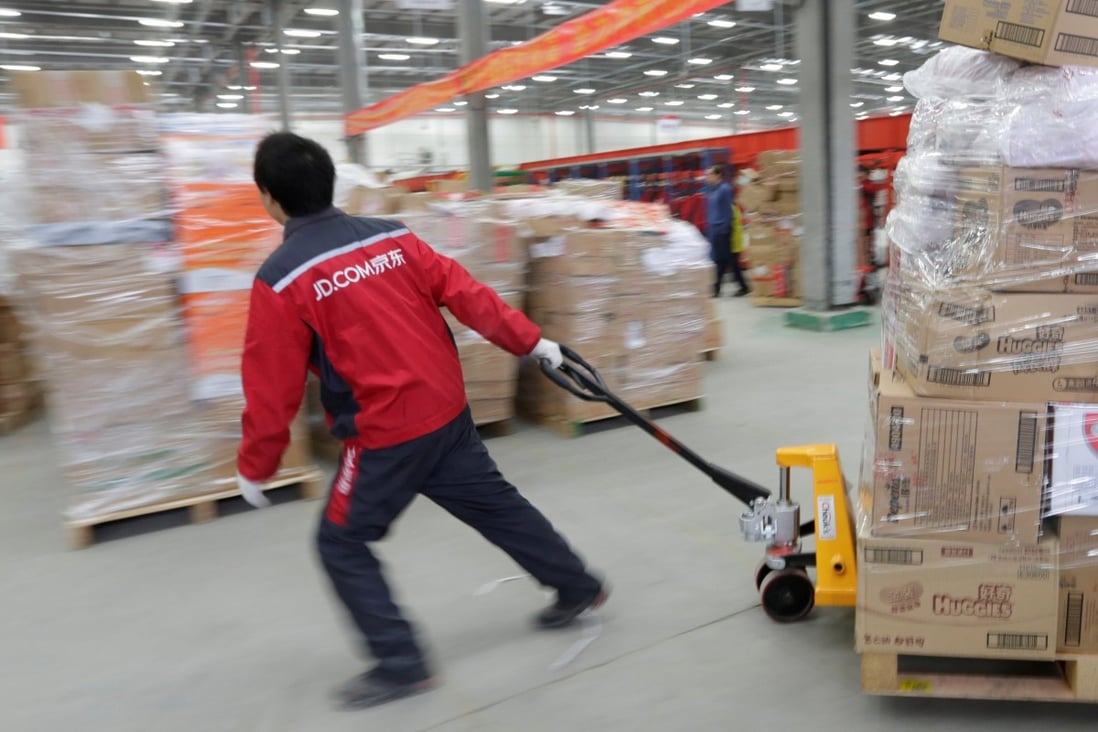 A worker moves goods at a JD.com logistics centre in Langfang, Hebei province, China. Photo: Reuters