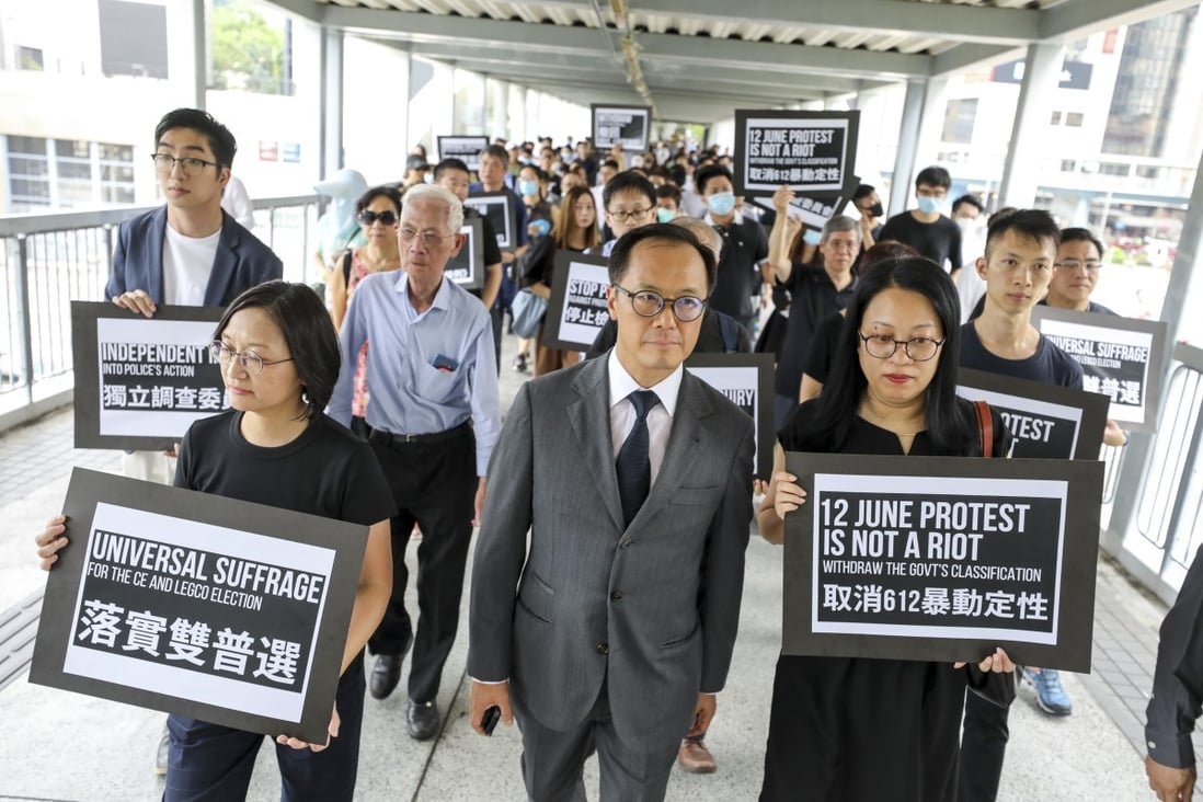 Accounting sector lawmaker Kenneth Leung (centre) with fellow protesters in Chater Garden on Friday. Photo: Dickson Lee