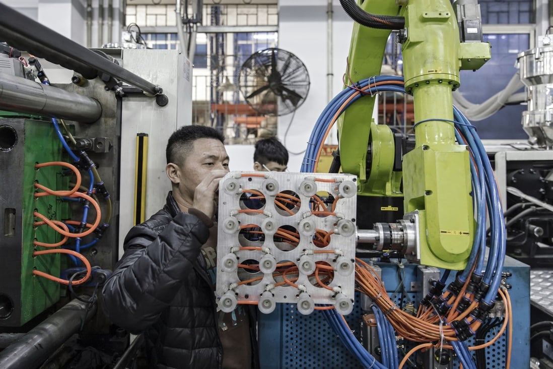 A technician adjusts an industrial robot as it stands on the production line of Guangdong Shiyi Furniture in Foshan, China. Exporters in Guangdong are hoping that the Chinese yuan may be devalued in order to help them deal with higher tariffs. Photo: Bloomberg