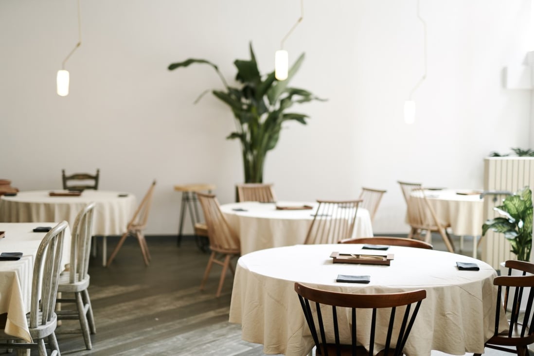 Nectar’s interiors are stark, with white tablecloths and plant accents.