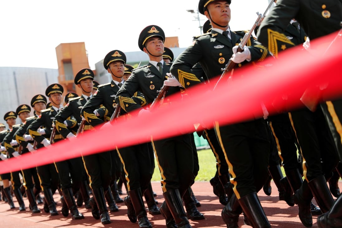 Members of the People’s Liberation Army honour guards march for the flag-raising ceremony during an open day, at the Hong Kong garrison’s naval base on Stonecutters Island on June 30. Photo: Reuters