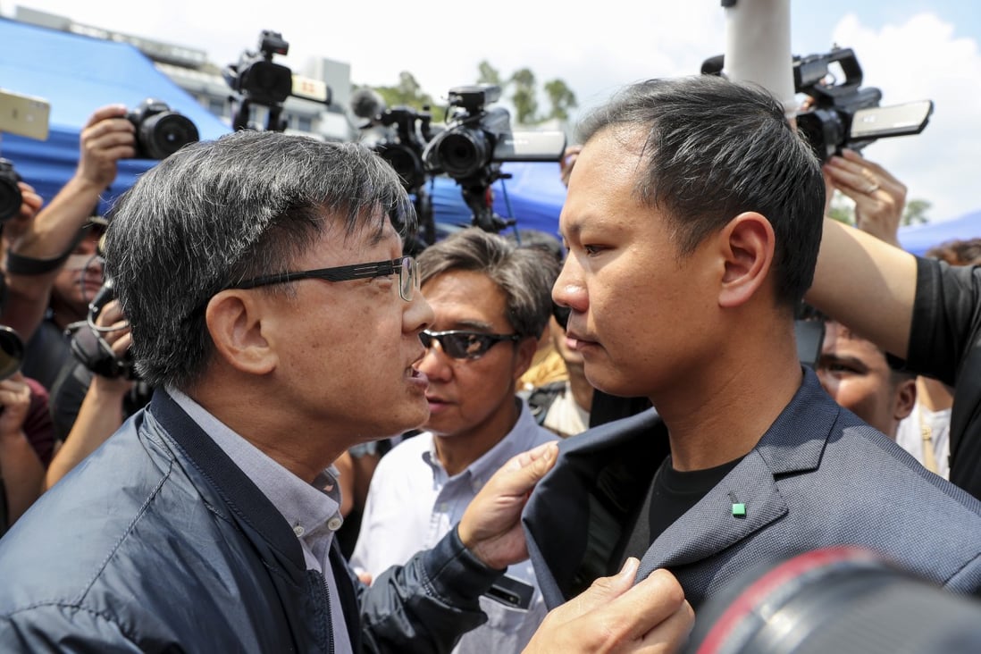 Pro-Beijing lawmaker Junius Ho Kwan-yiu (left) argues with pro-democracy lawmaker Dennis Kwok Wing-hang before a demonstration of a water cannon-equipped vehicle at the compound of the Police Tactical Unit in Fanling on August 12. Photo: Sam Tsang