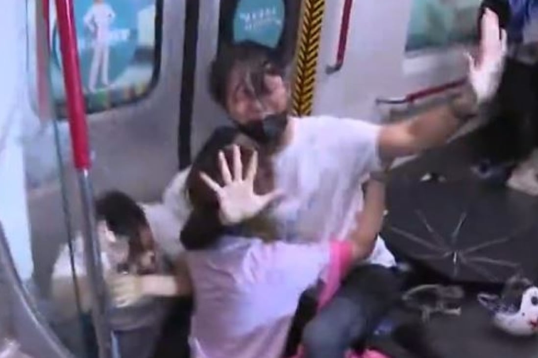 About five officers from the Special Tactical Squad hit four commuters inside an MTR train at Prince Edward station. Photo: TVB