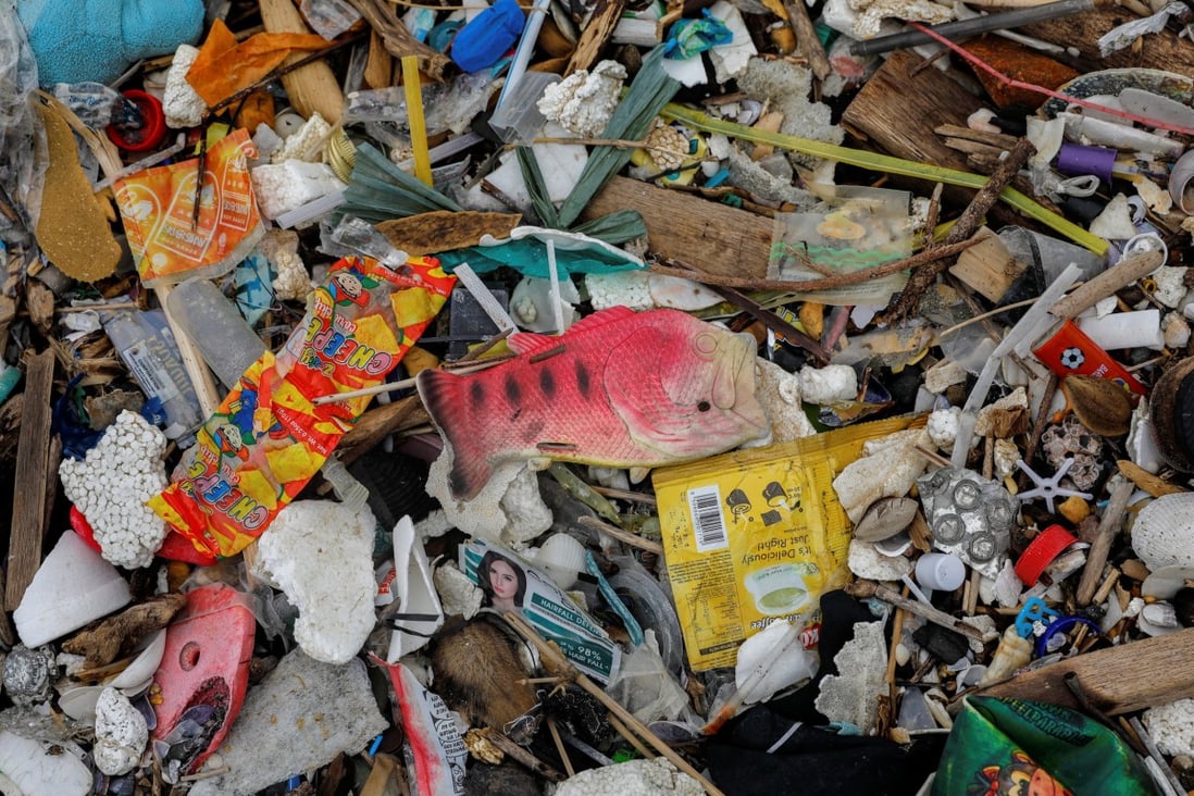 A plastic fish toy among sachets of various products on a trash-filled shore on Freedom Island. Photo: Reuters