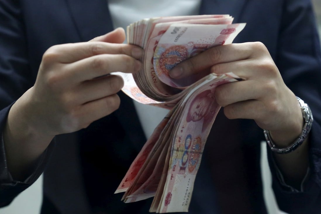 A clerk counting Chinese 100 yuan banknotes at a branch of a foreign bank in Beijing, China. Photo: Reuters