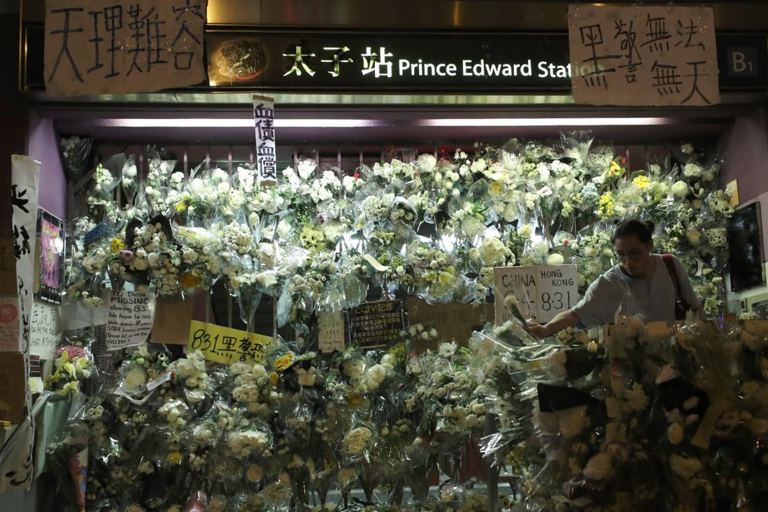 Flowers and other symbols of mourning have been placed on the gates of an exit of Prince Edward MTR station. Photo: Sam Tsang
