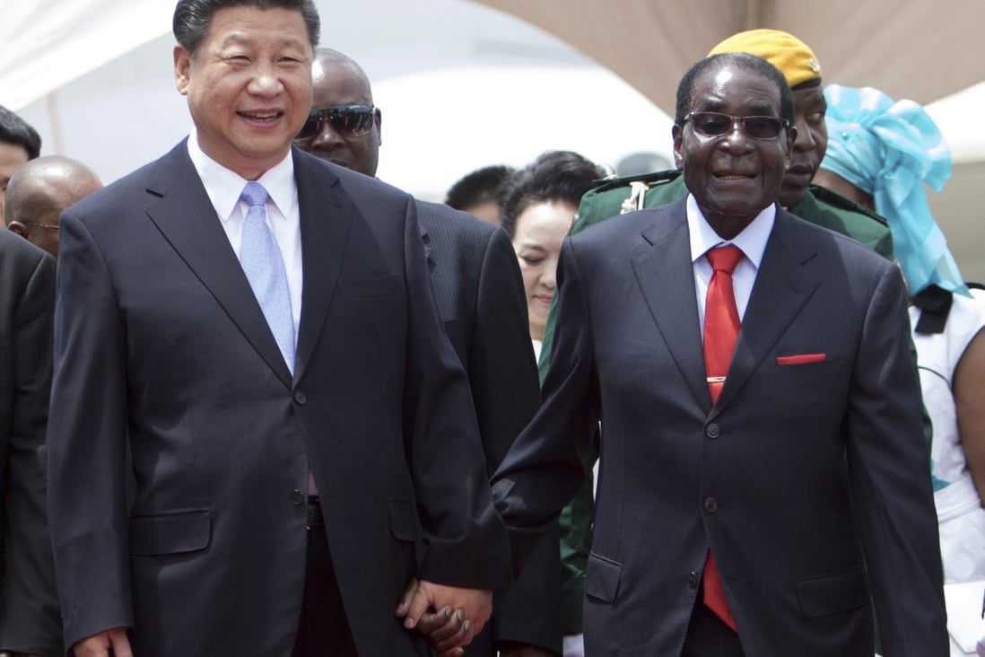 Chinese President Xi Jinping walks hand in hand with then-leader of Zimbabwe, Robert Mugabe, in Harare in 2015. Photo: AFP