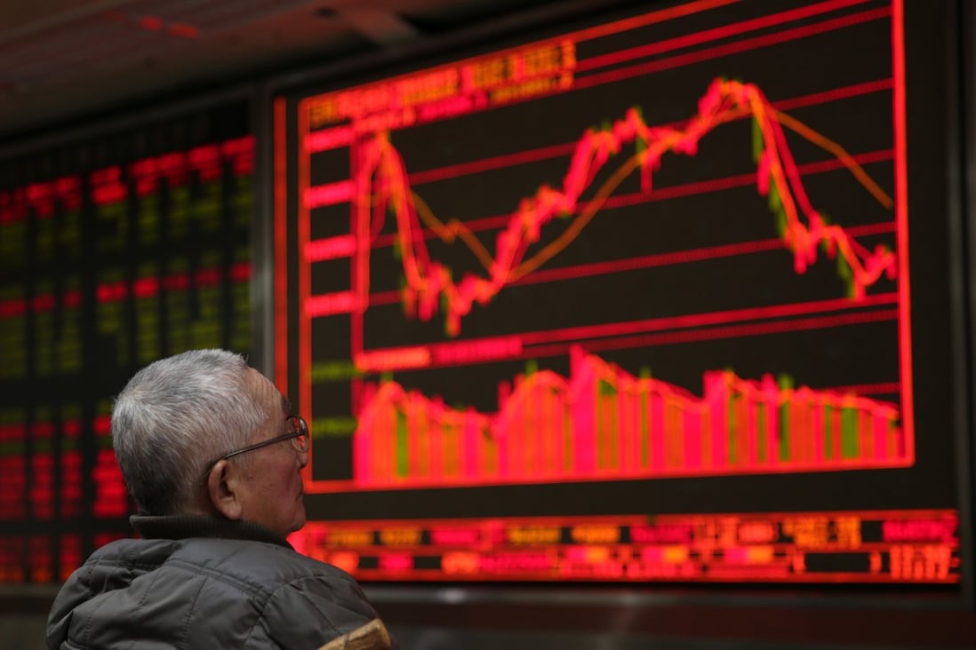 A Chinese investor before an electronic display of stock data at a brokerage house in Beijing on 15 February 2016. Contrary to global conventions, China represents gains and advances in red, using the colour green to denote losses and declines. Photo: EPA