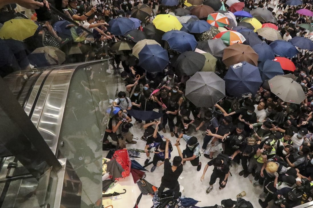 Policemen clash with protesters in New Town Plaza during a rally in Sha Tin on July 14. Photo: Felix Wong