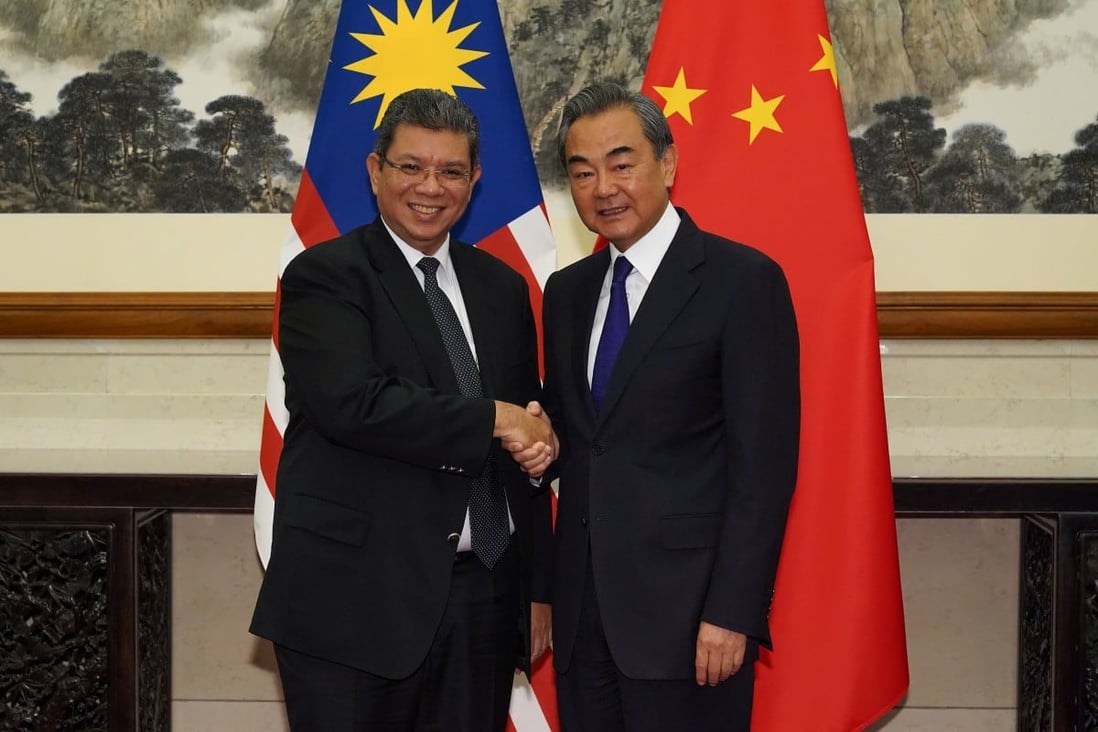 Chinese Foreign Minister Wang Yi (right) and his Malaysian counterpart, Saifuddin Abdullah, have agreed to set up a dialogue mechanism to handle South China Sea disputes. Photo: Reuters