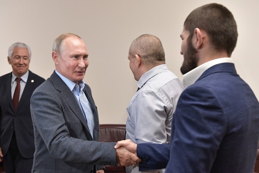 Russian President Vladimir Putin shakes hands with UFC lightweight champion Khabib Nurmagomedov during a meeting in Makhachkala, Russia. Photos: EPA