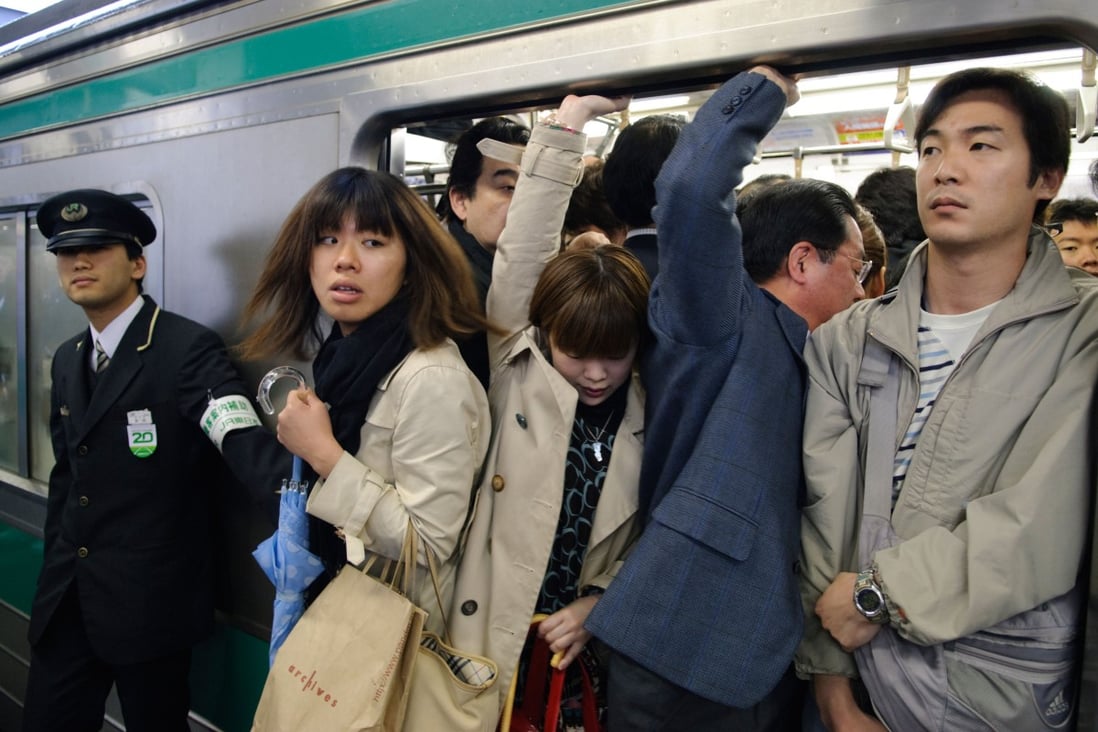 Commuters cram into a train in Japan. With sexual assault rife on public transport, a variety of deterrents have been thought up. Photo: Alamy