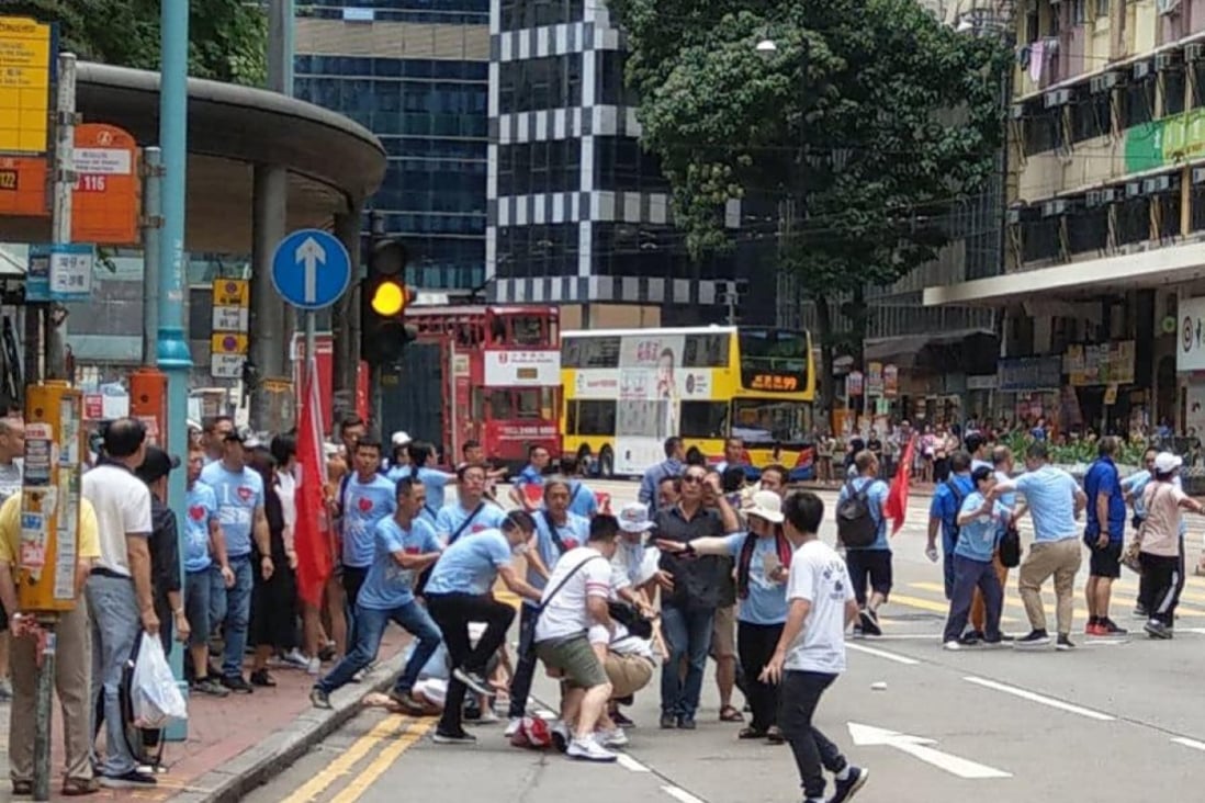 A group of government supporters clash with local residents outside Fortress Hill MTR station on Saturday. Photo: Facebook