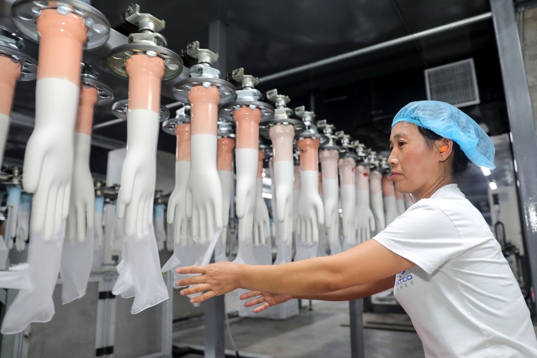 An employee working on a medical glove production line at a factory in Huaibei in China's eastern Anhui province. Photo: AFP