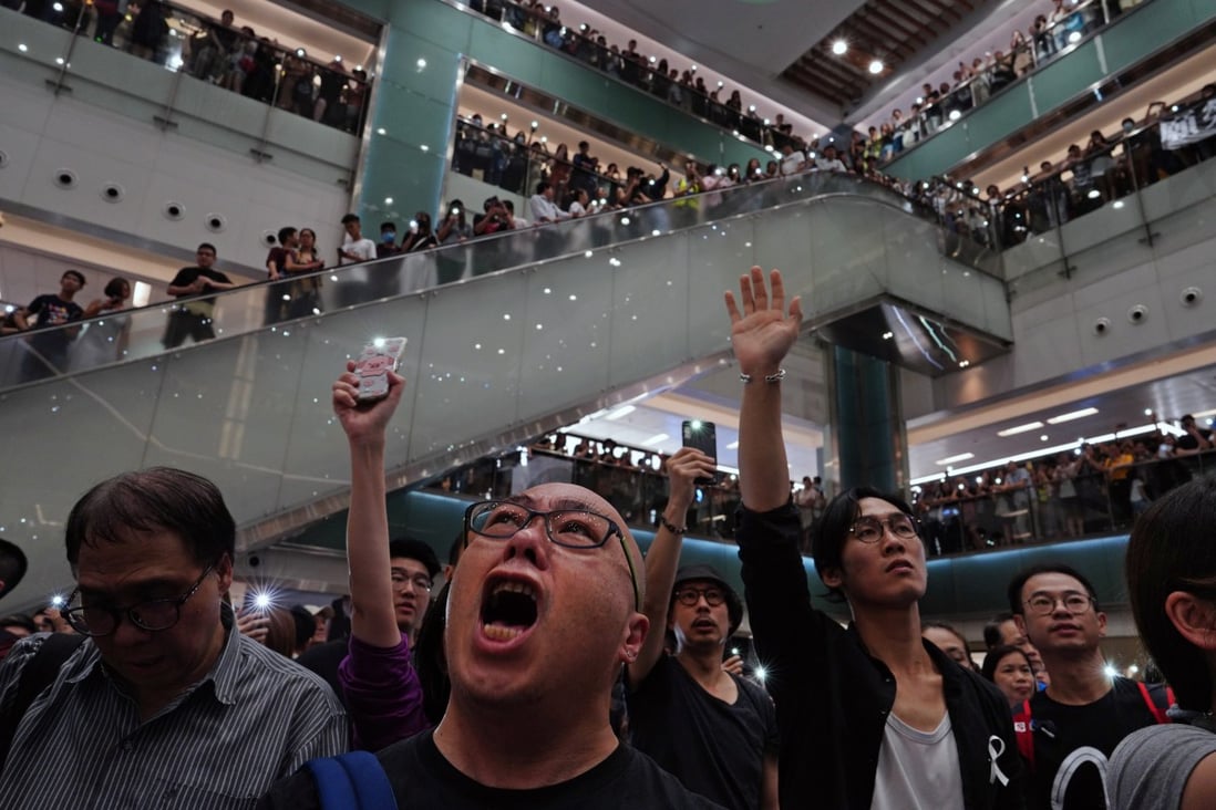 Local residents sing Glory to Hong Kong at a shopping mall on September 11. Protesters have found a sense of community in gathering to call for reform and to defend their way of life. Photo: AP