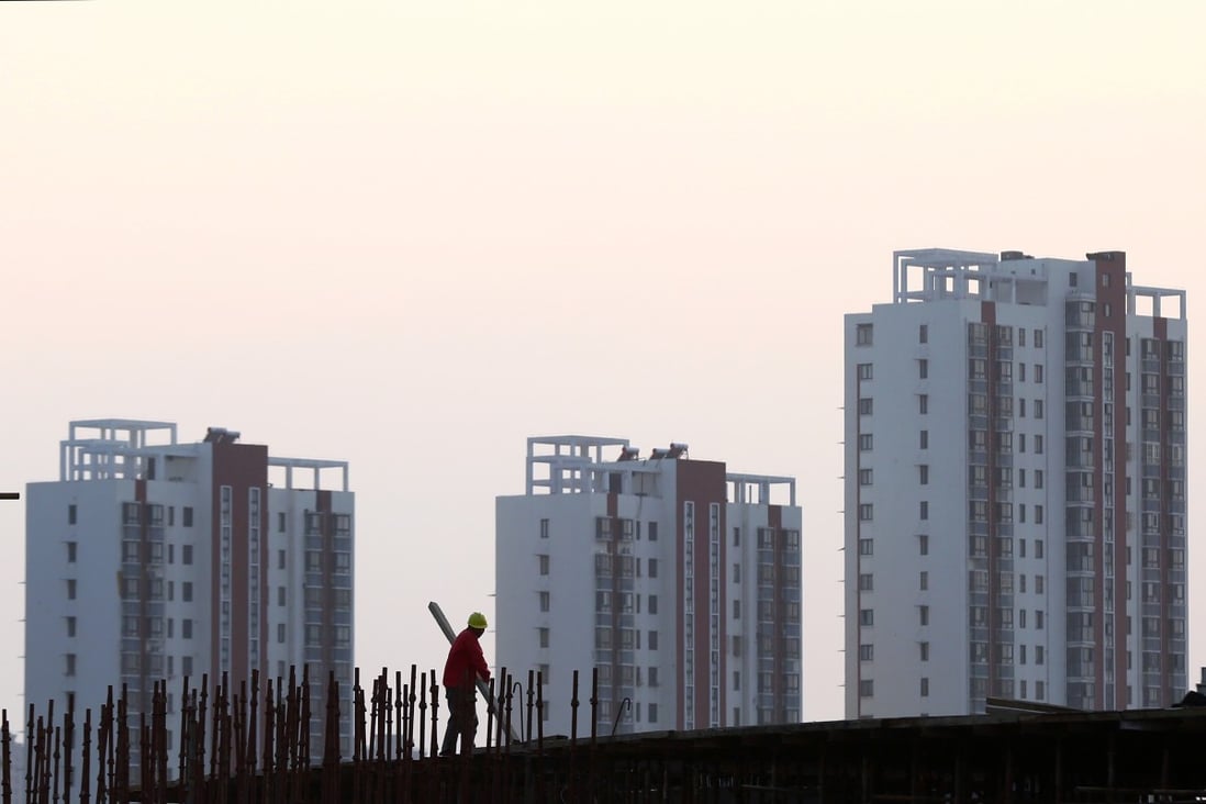 A worker stands on the scaffolding at a construction site in Huaian, Jiangsu province, China. Photo: Reuters