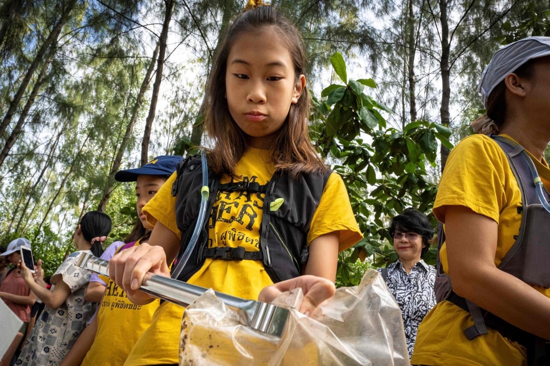 12-year-old Ralyn Satidtanasarn, known by her nickname Lilly, collects plastic waste during a clean-up by Thai NGO Trash Hero at the Khung Bang Kachao urban forest and beach in Bangkok. She paddles the city’s canals picking up plastic and other waste, sometimes skipping class to do so. Photo: Mladen Antonov/AFP