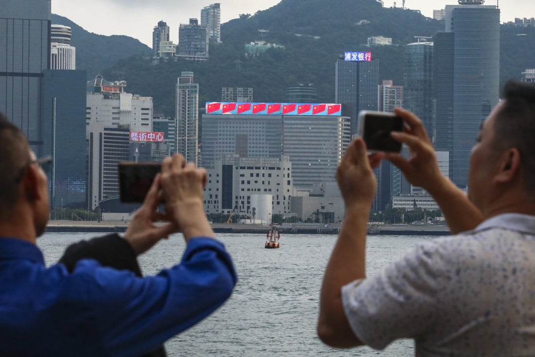 Tourists at Victoria Harbour in Hong Kong’s Tsim Sha Tsui. Photo: Felix Wong