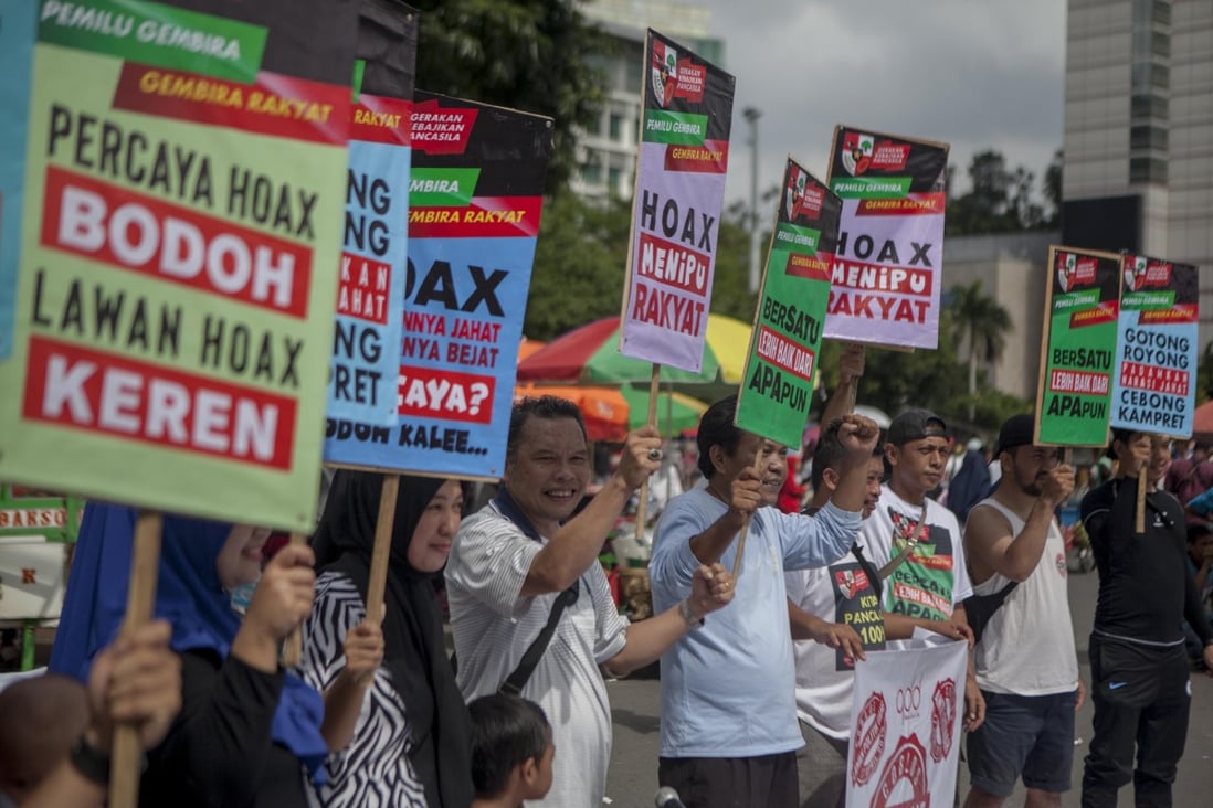 Residents of Jakarta carry placards during an anti-hoax campaign. Photo: Handout