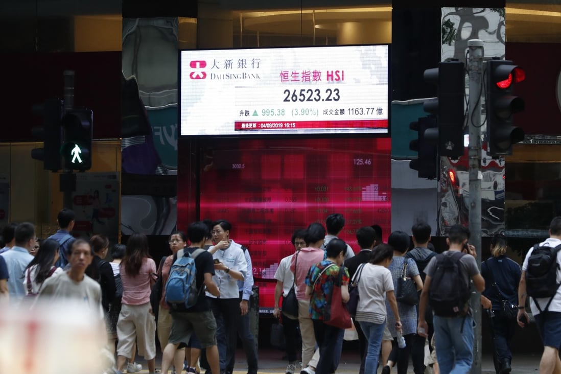 Pedestrians next to an electronic billboard with the Hang Seng Index (HSI) data in Hong Kong on 4 September 2019. Photo: EPA-EFE
