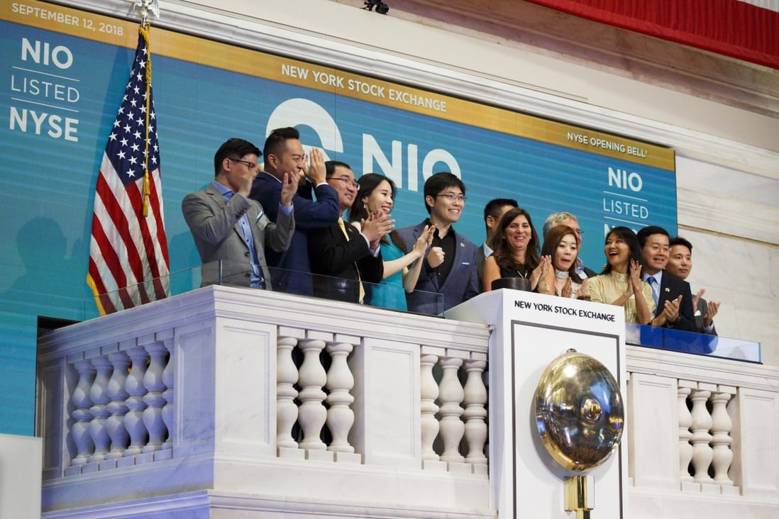 NIO's first employee Li Tianshu (centre) and members of the company's leadership team ring the opening bell of the New York Stock Exchange before the company’s initial public offering on 12 September 2018. Photo: EPA-EFE