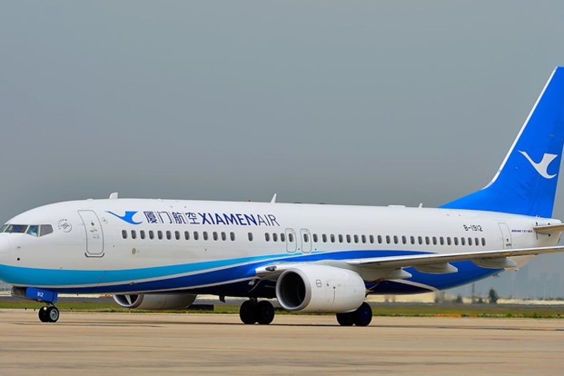 === PHOTO CAPTURED FROM WEIBO === A flight was delayed for an hour and a woman detained by police after she opened the emergency exit for Òa breath of fresh airÓ before the flight took off in central Hubei province on Monday. The incident happened on flight Xiamen Air MF8215, which was scheduled to take off in Wuhan at 15:45 after passengers boarded the plane for Lanzhou, Gansu province on the afternoon, reported the Btime Video. Air stewardess had briefed the woman, who looked to be in her 50s, about the rules of sitting next to the emergency exit and reminded her not to touch the button that could open the emergency exit. WEIBO