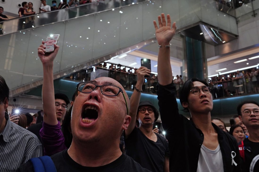 People sing Glory to Hong Kong in a shopping mall in the city earlier this month. Crowds have gathered in several malls to sing the song, which has become the anthem of anti-government protests that have rocked Hong Kong since June. Photo: AP