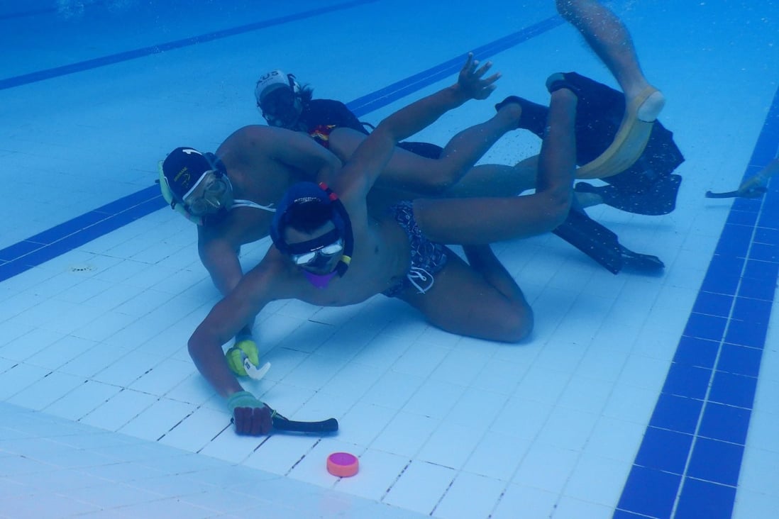 Indonesia’s men’s underwater hockey team practice during a training session at the Senayan Aquatic Centre in Jakarta ahead of the Southeast Asian (SEA) Games. Photo: AFP