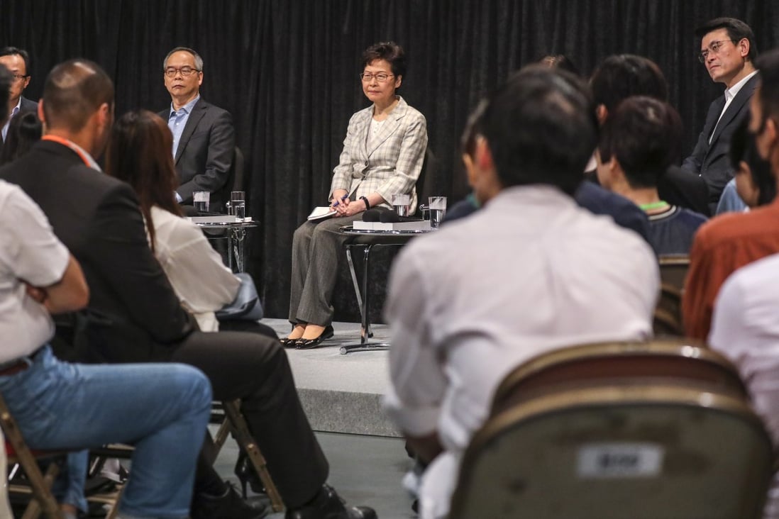Carrie Lam (centre) meets the public during her dialogue session at Queen Elizabeth Stadium in Wan Chai. Photo: Dickson Lee