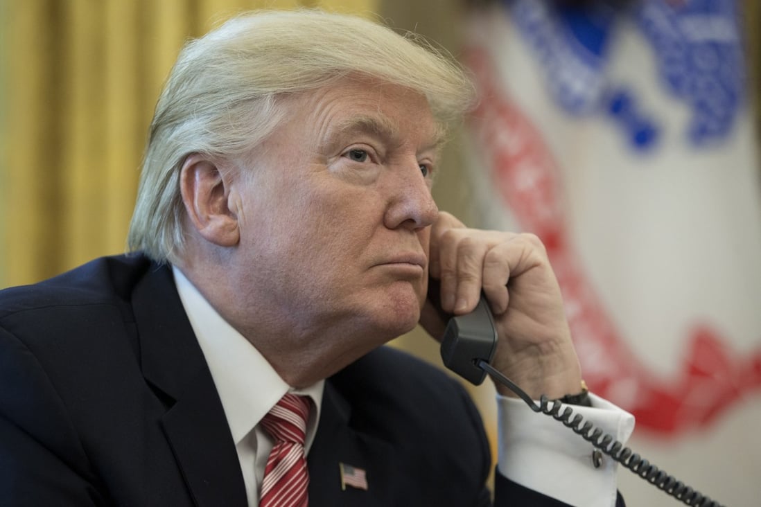 US President Donald Trump makes a phone call in the Oval Office. File photo; AFP